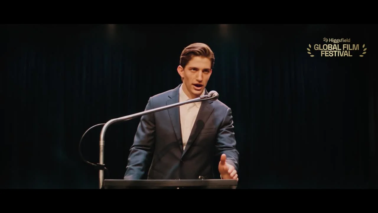 A character addressing an audience from a dark stage in ALGORITHM